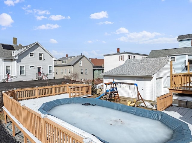 deck featuring a residential view and a playground