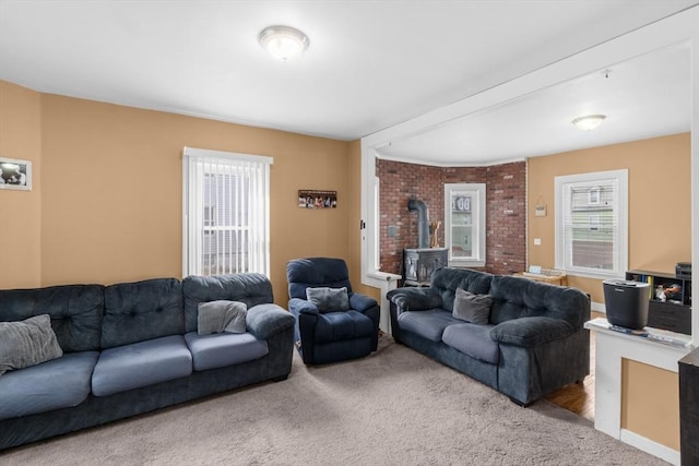 carpeted living room featuring a wood stove