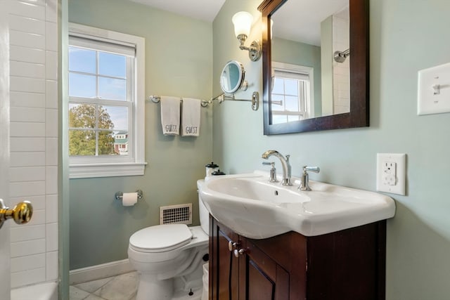 bathroom featuring vanity, toilet, tile patterned floors, and a tile shower