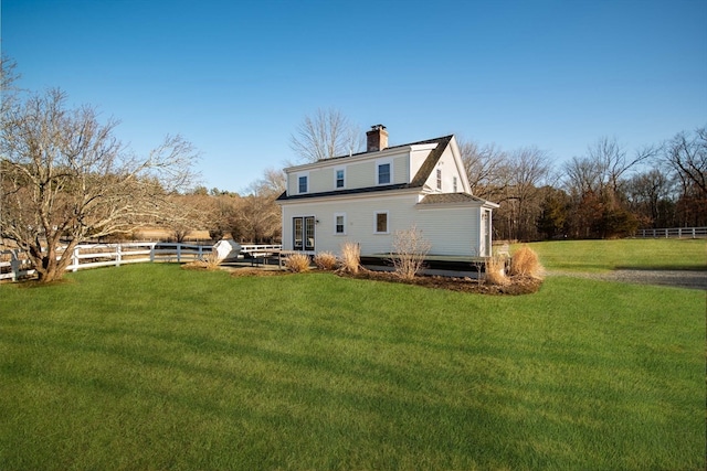 back of house featuring a lawn