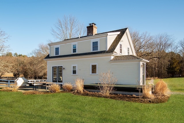 rear view of house with a lawn