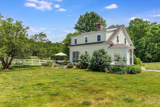 back of house with a lawn