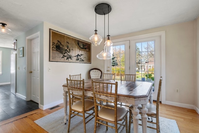 dining space with light wood-type flooring