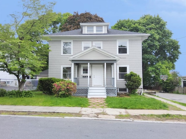 22 Ridge Rd, Lawrence, MA 01841 - american foursquare style home with covered porch and a front lawn