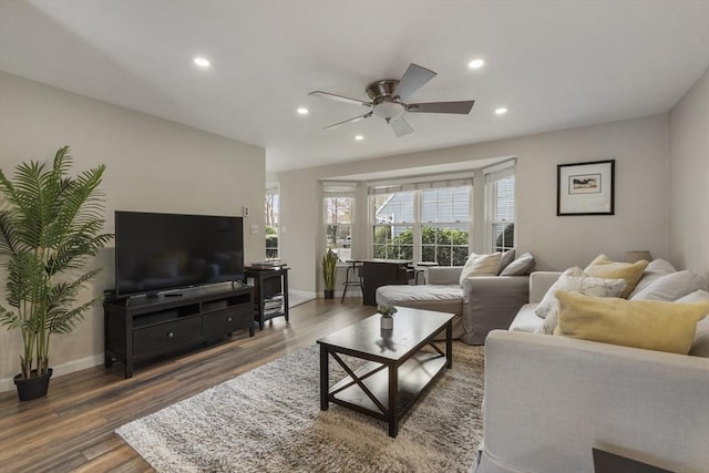 living room featuring recessed lighting, a ceiling fan, and wood finished floors
