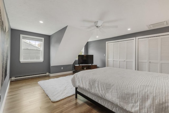 bedroom with visible vents, multiple closets, recessed lighting, and baseboard heating
