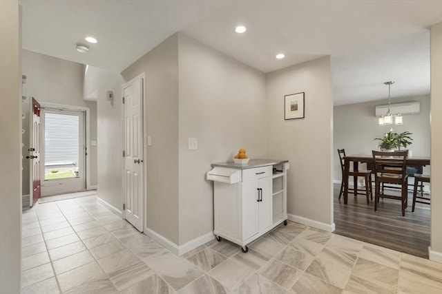 hallway with a wall mounted air conditioner, recessed lighting, light tile patterned floors, and baseboards