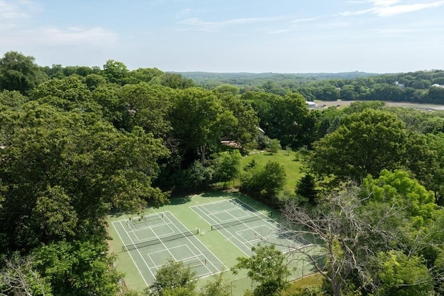 drone / aerial view with a wooded view