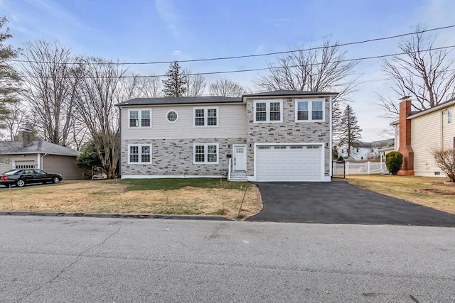 view of front of property with a front yard and a garage