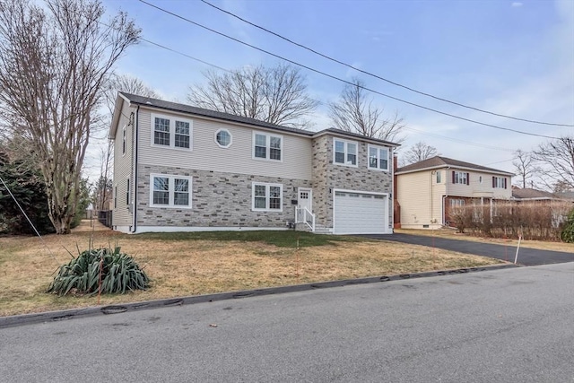 view of front of property with a garage and a front yard