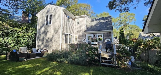 back of house featuring an outdoor hangout area and a lawn