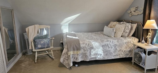 carpeted bedroom featuring lofted ceiling