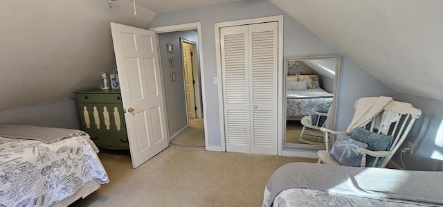 carpeted bedroom featuring lofted ceiling and a closet