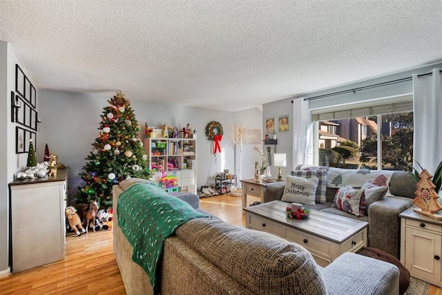 living room with light hardwood / wood-style floors and a textured ceiling