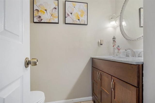 bathroom with tile patterned floors, vanity, and toilet