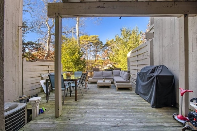 wooden terrace featuring outdoor lounge area, grilling area, and central air condition unit