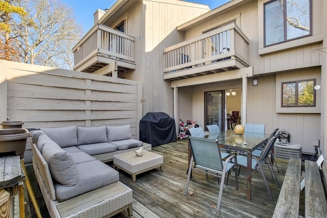 wooden deck featuring an outdoor living space and area for grilling