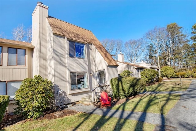 view of property exterior featuring a lawn