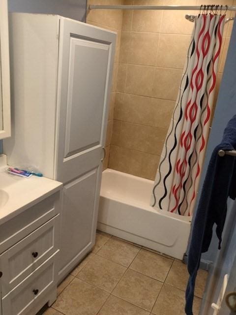 bathroom featuring tile patterned floors, shower / tub combo with curtain, and vanity