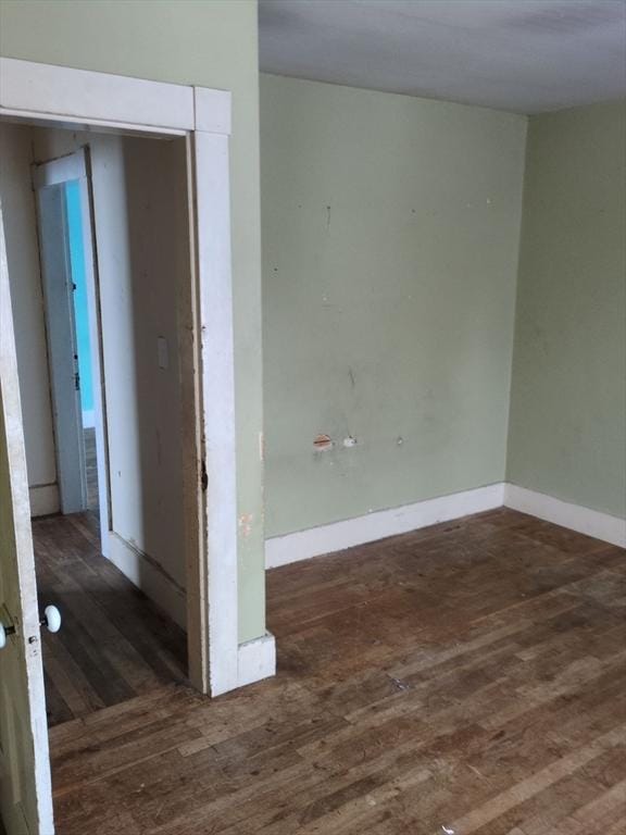 empty room with dark wood-type flooring