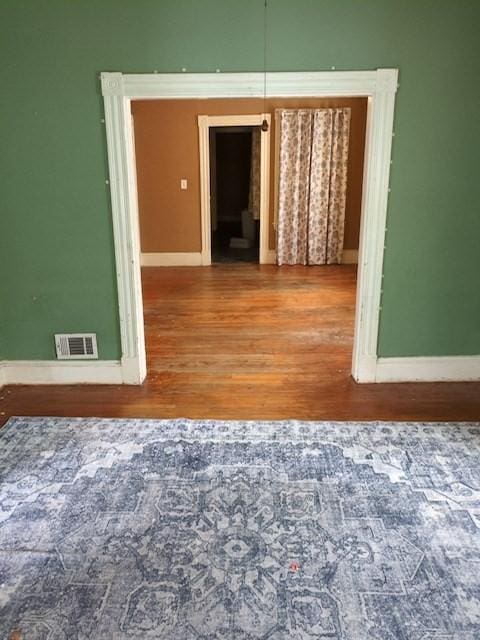 unfurnished room with wood-type flooring