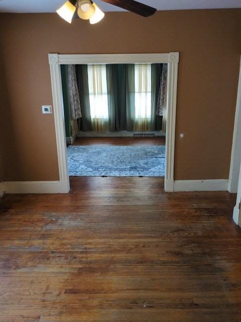 unfurnished room with ceiling fan and dark hardwood / wood-style floors