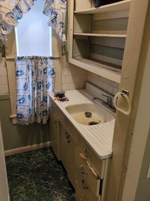 bathroom with tasteful backsplash and vanity