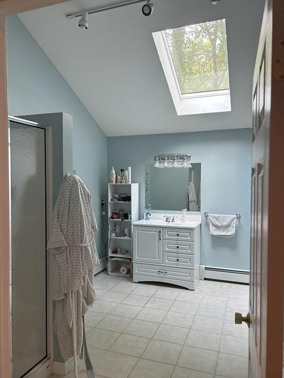 11 Solitaire Dr, Haverhill, MA 01830 - full bathroom featuring lofted ceiling, vanity, baseboard heating, a stall shower, and a skylight
