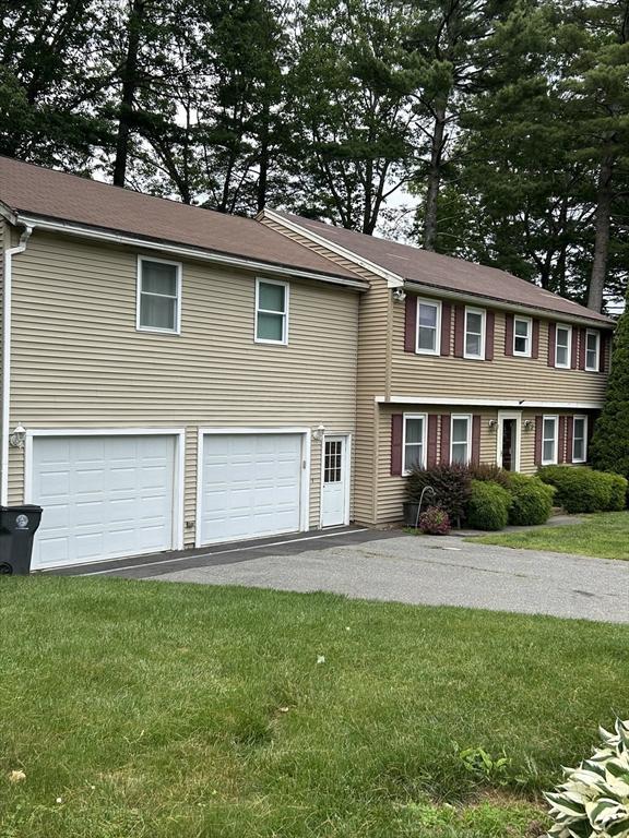 11 Solitaire Dr, Haverhill, MA 01830 - view of front of property with a garage, asphalt driveway, and a front lawn