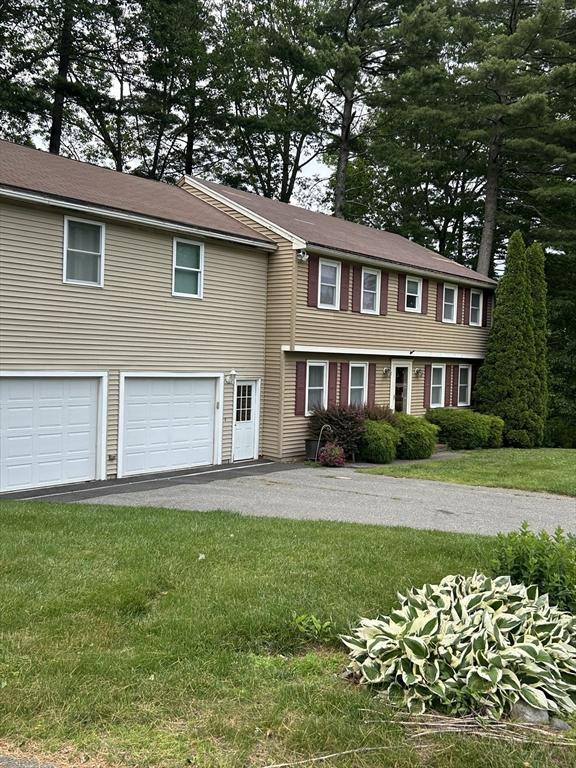 11 Solitaire Dr, Haverhill, MA 01830 - view of front of house with a garage, driveway, and a front yard