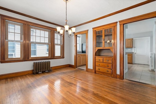 25-27 Morrow Rd, Boston, MA 02135 - unfurnished dining area featuring radiator heating unit, a chandelier, light wood-style floors, radiator, and ornamental molding