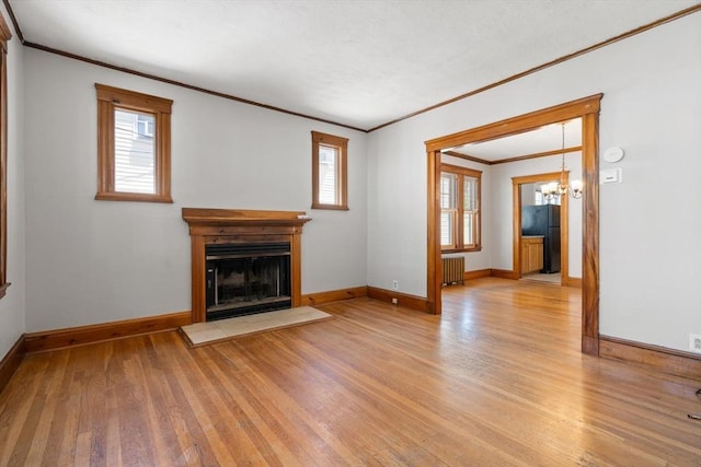 25-27 Morrow Rd, Boston, MA 02135 - unfurnished living room with ornamental molding, radiator heating unit, light wood-style floors, healthy amount of natural light, and a chandelier