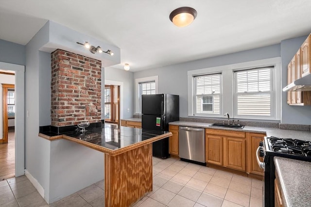 25-27 Morrow Rd, Boston, MA 02135 - kitchen with stainless steel dishwasher, freestanding refrigerator, gas range, light tile patterned floors, and a peninsula