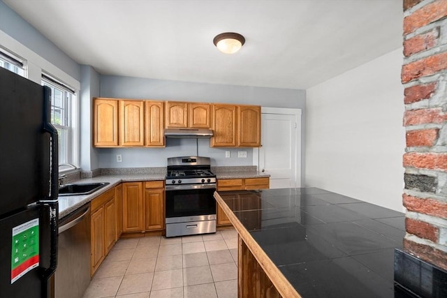 25-27 Morrow Rd, Boston, MA 02135 - kitchen with appliances with stainless steel finishes, under cabinet range hood, light tile patterned flooring, and tile counters