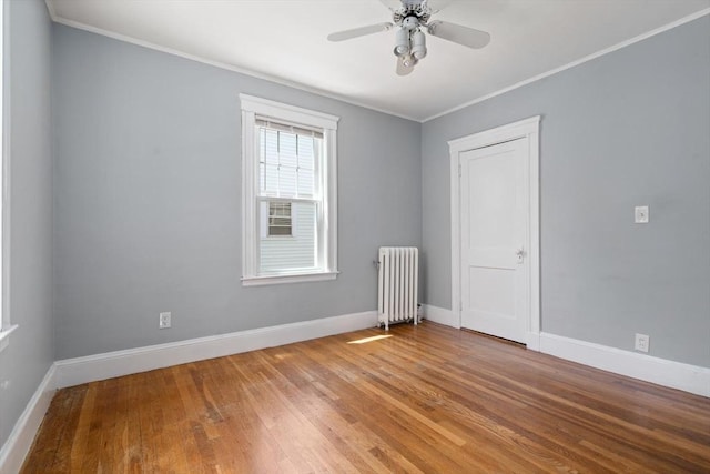 25-27 Morrow Rd, Boston, MA 02135 - spare room with radiator heating unit, ornamental molding, light wood-style flooring, and ceiling fan