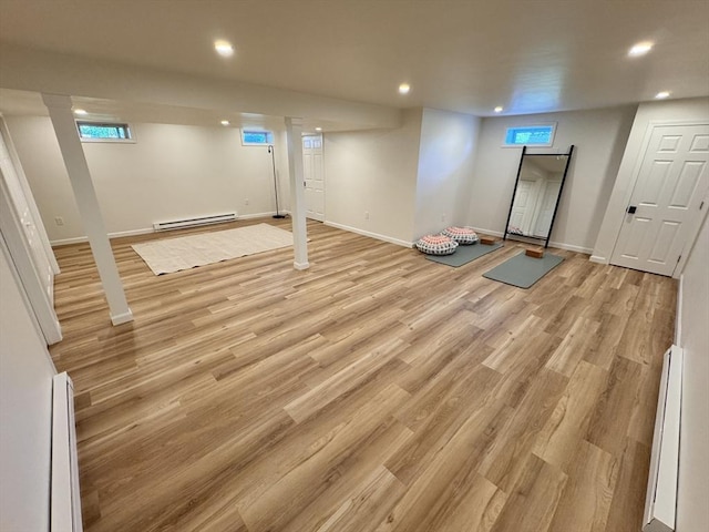 54 Vose St, Framingham, MA 01702 - basement featuring baseboard heating, recessed lighting, light wood finished floors, and a baseboard radiator
