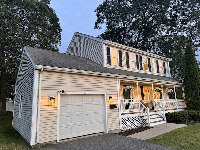 54 Vose St, Framingham, MA 01702 - view of front of home featuring a porch and asphalt driveway