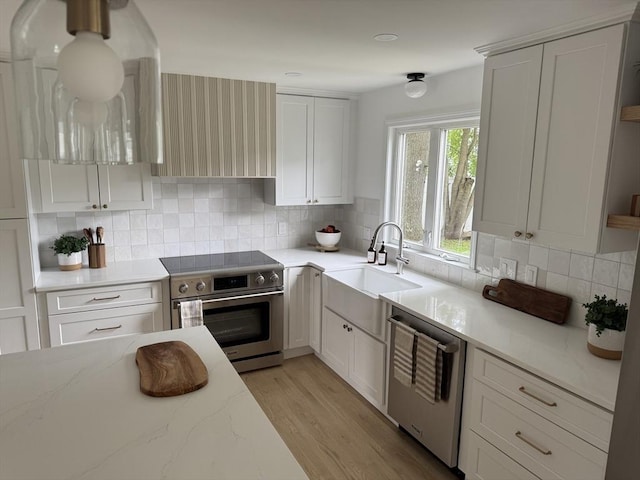 54 Vose St, Framingham, MA 01702 - kitchen with appliances with stainless steel finishes, light wood-style flooring, and backsplash