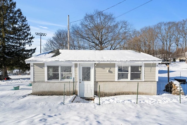 view of snow covered back of property