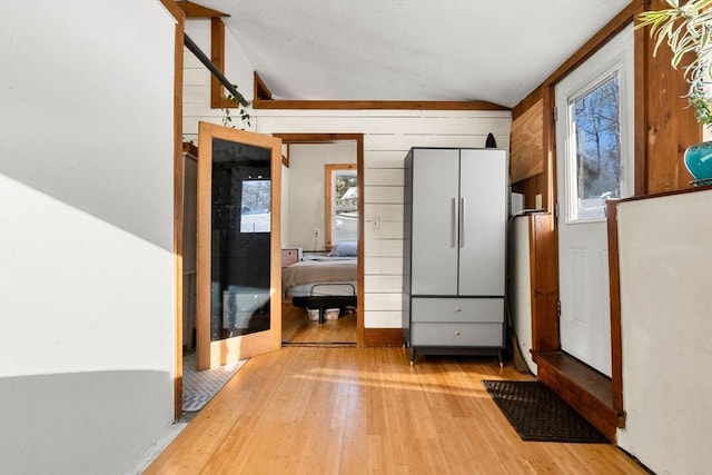 interior space featuring light hardwood / wood-style floors and wood walls