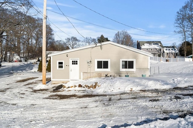 view of snow covered back of property