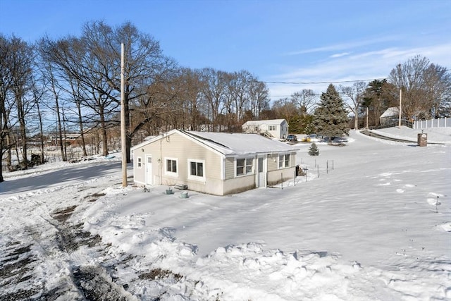 view of snow covered back of property