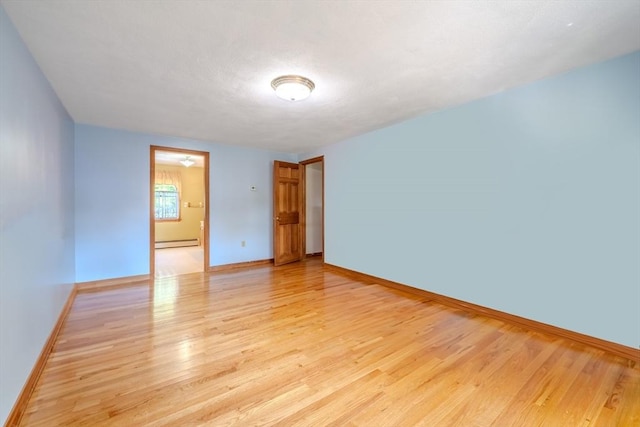 12 Jensen Ave, Chelmsford, MA 01824 - spare room featuring a baseboard radiator, light wood finished floors, and baseboards