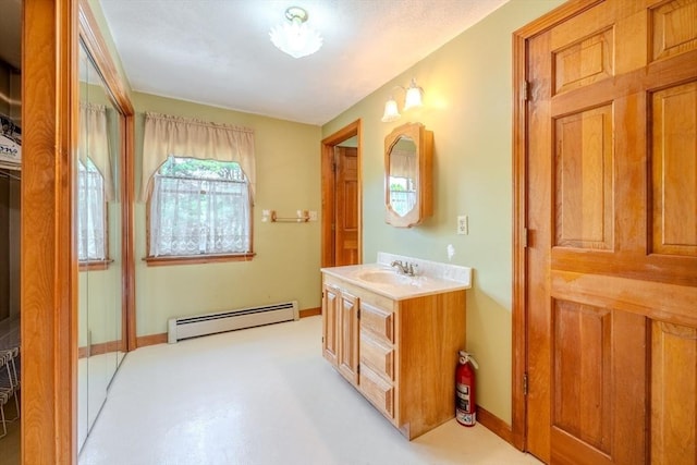 12 Jensen Ave, Chelmsford, MA 01824 - bathroom featuring baseboard heating, vanity, and baseboards