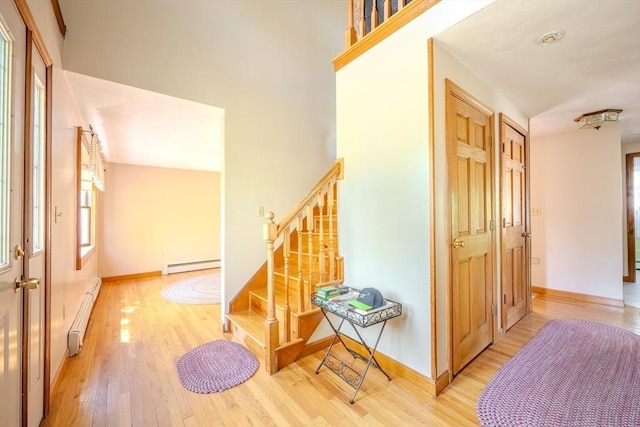 12 Jensen Ave, Chelmsford, MA 01824 - foyer entrance with a baseboard heating unit, a baseboard radiator, plenty of natural light, and wood finished floors