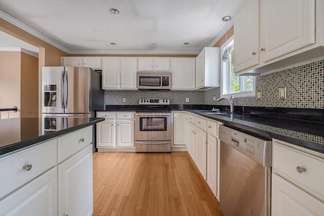 998 Wood, Swansea, MA 02777 - kitchen featuring stainless steel appliances, a sink, white cabinets, crown molding, and light wood-type flooring