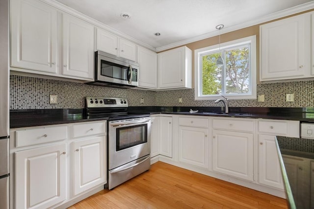 998 Wood, Swansea, MA 02777 - kitchen featuring stainless steel appliances, a sink, white cabinetry, dark countertops, and decorative backsplash