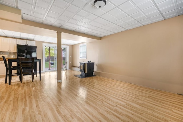 998 Wood, Swansea, MA 02777 - living area with a wood stove, light wood finished floors, and baseboards