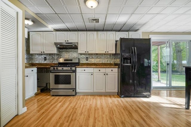 998 Wood, Swansea, MA 02777 - kitchen with black refrigerator with ice dispenser, stainless steel range with gas stovetop, under cabinet range hood, and dark countertops