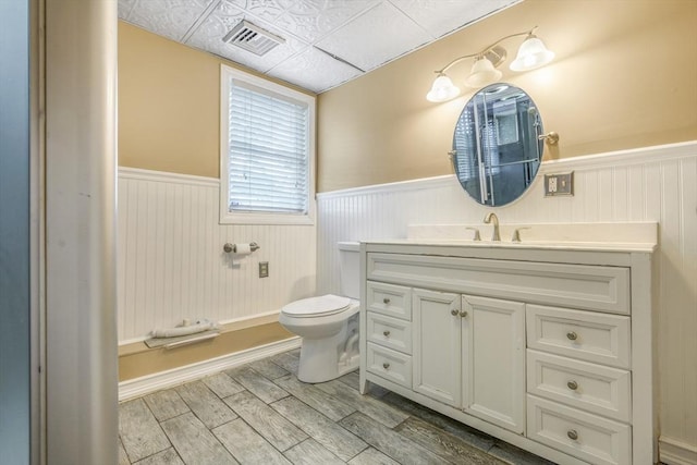 998 Wood, Swansea, MA 02777 - bathroom featuring wainscoting, toilet, wood finished floors, and vanity